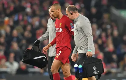 Fabinho leaves Anfield in protective boot after worrying ankle injury