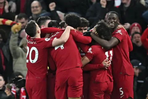 Who starts in the three-man attack for Liverpool?