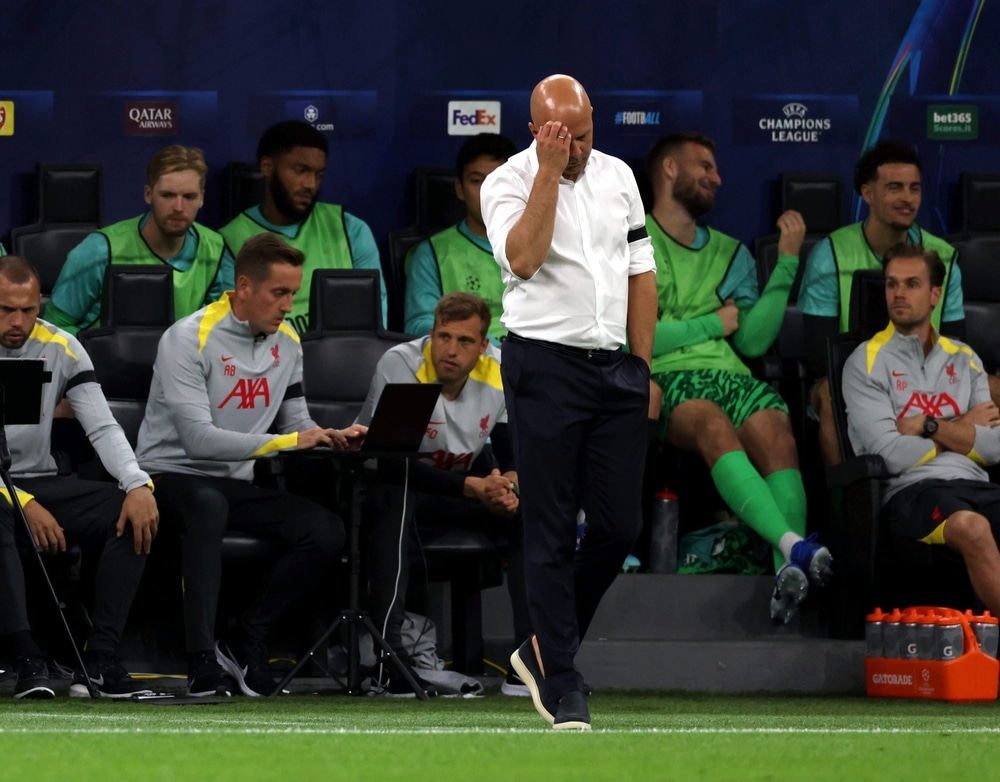 Arne Slot wiping his forehead and looking concerned during the Liverpool press conference ahead of the Champions League match against Qarabag.
