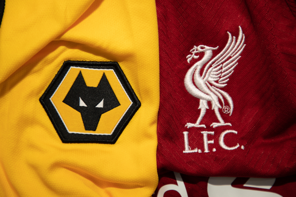 Liverpool FC and Wolverhampton Wanderers club logos on team shirts side-by-side.