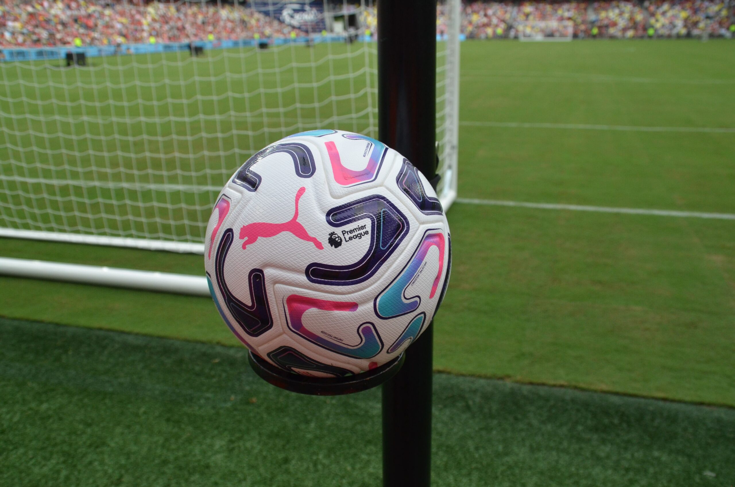 Official Premier League match ball resting on the pitch during the Liverpool vs Leeds United match at Soldier Field