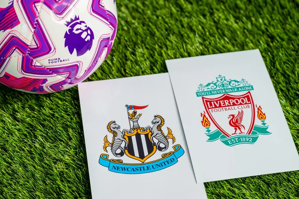 Liverpool FC and Newcastle United club crests with a Premier League football ahead of Andoni Iraola's opening day match