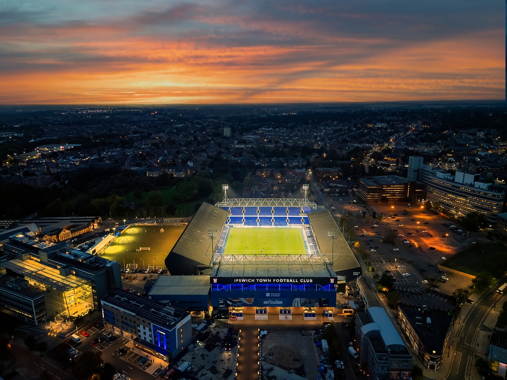 Dramatic sunset aerial view of Portman Road stadium illuminated for Ipswich Town vs Liverpool FC